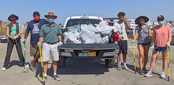 Sailing Science Center volunteers clean up litter at Clipper Cove, Treasure Island, San Francisco.